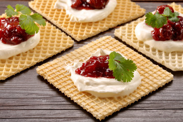 Yellow waffle with white cottage cheese cherry jam and fresh her