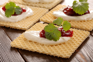 Yellow waffle with white cottage cheese cherry jam and fresh her