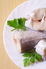 fish, hake on wooden background