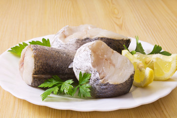 fish, hake on wooden background