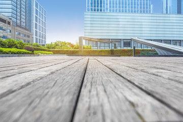 empty wooden floor with modern building in city