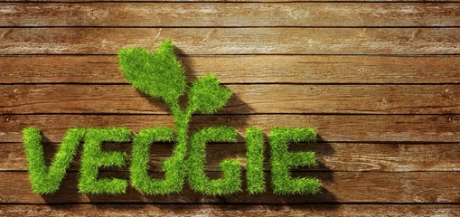 Veggie made of grass on wood background
