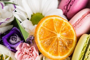 close-up of orange slice in a cymbidium orchid flower compositio