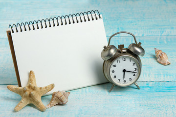 open notebook with cope space near alarm clock