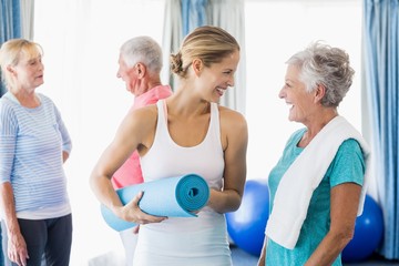 Instructor standing together with seniors