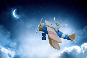 Obraz na płótnie Canvas Girl flying old plane . Mixed media
