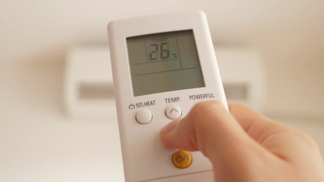 Air conditioner remote use for setting lower temperature and cooling down the room 4K 2160p UHD footage - Air conditioning room temperature by remote control 4K 3840X2160 UHD video 