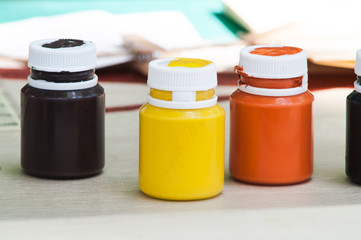 colored cans of paint for painting