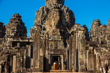 The monks in the ancient stone faces of Bayon temple