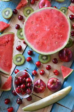 rustic table full of pieces of watermelon, melon