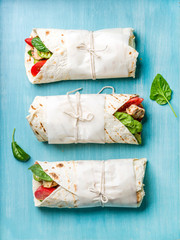 Healthy lunch snack. Tortilla wraps with grilled chicken fillet and fresh vegetables