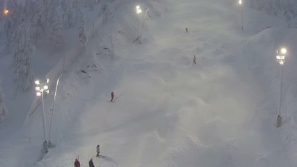Sportsmen are having a training on the slope for mogul skiing, aerial shot