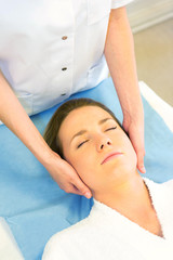 Obraz na płótnie Canvas Detail of a woman face receiving a relaxing facial massage