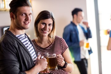 Happy young couple with beer mug