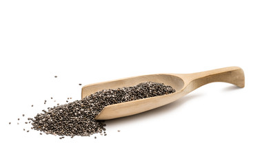 Wooden spoon and chia seeds on a white background seen from the side