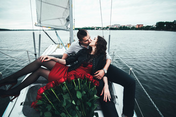 Pretty couple outdoor  relaxing on the yacht