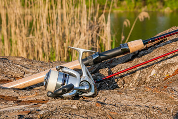 Fishing rod and reel on the natural background.