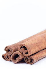 Cinnamon sticks over white with copy space
