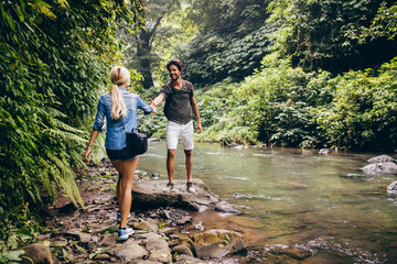 Young couple walking by the mountain stream © Jacob Lund