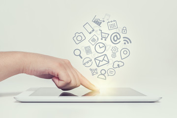 woman touching tablet computer screen and media icons fly