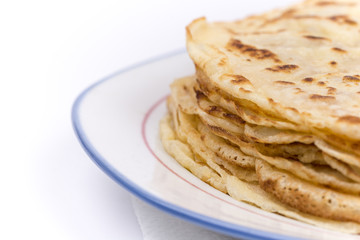 Homemade pancakes on the plate. Isolated on white background.