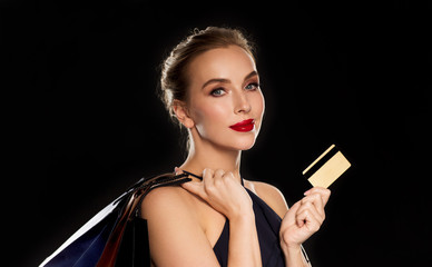 woman with credit card and shopping bags