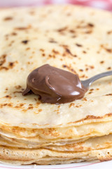 Chocolate cream on the spoon with blurred background