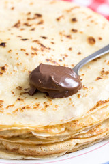 Chocolate cream on the spoon with blurred background