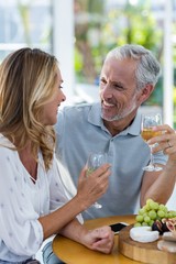 Couple smiling while holding wineglass