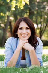 Portrait of a young brunette woman in the park