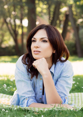 Portrait of a young brunette woman in the park