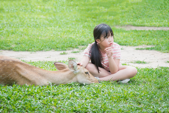 Beautiful Asian girl consolating antelope