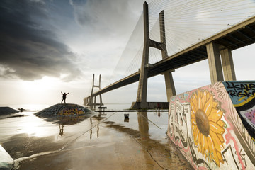 The colorful murals around Vasco Da Gama bridge emphasize its architecture and atmosphere at dawn, Lisbon, Portugal