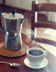 Geyser coffee maker and cup of black coffee - obrazy, fototapety, plakaty