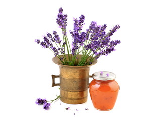 Jam jar with apricot jam and lavender in mortar.