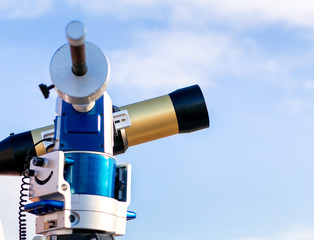 Amateur solar telescope on a blue sky day. The concept of a scie