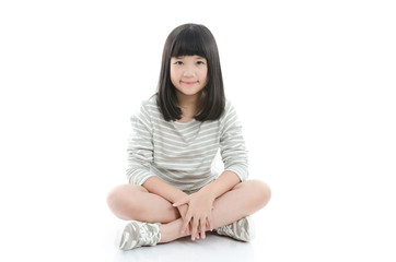 Beautiful asian girl sitting on white background