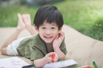 child drawing picture with crayon