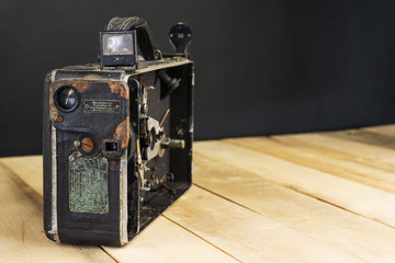 Very old handheld video camera on wooden desk