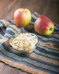 bowl of muesli, apple, nuts, flakes, candied  for a nutritious breakfast with a low glycemic index ensuring plenty of energy for the day. 