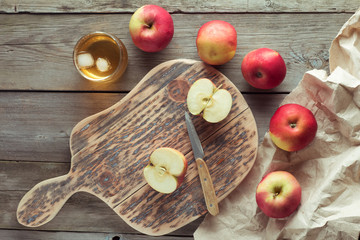 apples on a cutting board and glass of juice