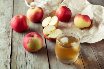 Naklejka na ściany i meble glass of juice with ice and apple in background
