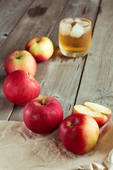 Naklejka na ściany i meble Whole and sliced apples, juice in background
