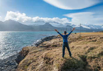 The man standing in front of the mountain range in East Iceland.