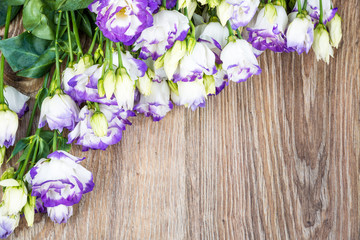 Eustoma flowers on wooden background