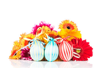 Easter eggs and flowers on white background