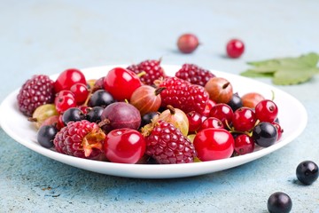 a variety of wild berries on a plate.selective focus