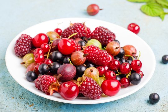 a variety of wild berries on a plate.selective focus