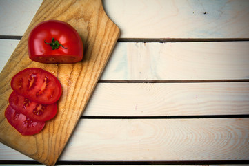 Cutted tomatoes on wooden table