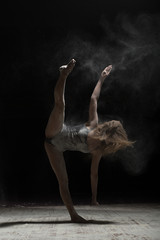 Obraz na płótnie Canvas Woman doing vertical splits and sprinkle flour